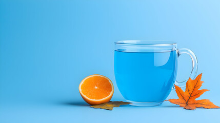 Blue Tea in Glass Mug with Orange and Maple Leaf