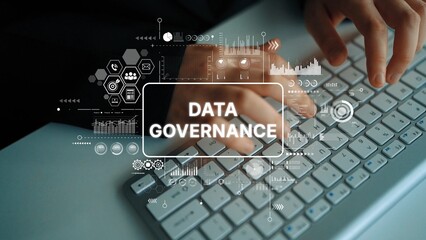 Hands typing on keyboard with digital graphics illustrating data governance concepts and analytics,...