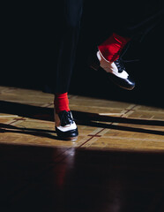 Couples dancing retro jazz swing and lindy hop, dancing suede shoes view, dancers in a ballroom club wooden floor, female and male dancing evening night, dance performance rehearsal lessons