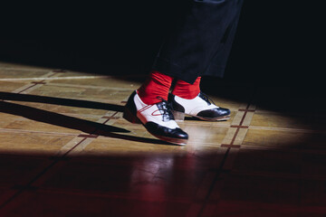 Couples dancing retro jazz swing and lindy hop, dancing suede shoes view, dancers in a ballroom club wooden floor, female and male dancing evening night, dance performance rehearsal lessons