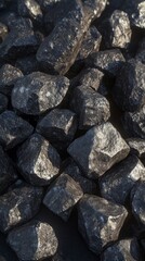 Close-up Pile of Small, Rough Coal Pieces on Dark Dusty Surface, Matte Black Texture