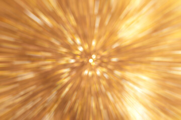 Obraz premium Abstract golden light burst with radial motion effect creating a dynamic composition