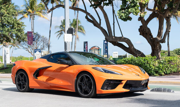 Miami, Florida, USA - December 20, 2024: Sport car of Chevrolet Corvette. Car of Chevy Corvette orange color outdoor. Chevrolet Corvette, side view. Chevrolet Corvette C8 Chevy supercar sportscar