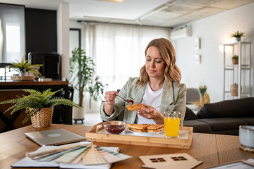 Interior designer enjoying breakfast while working from home office