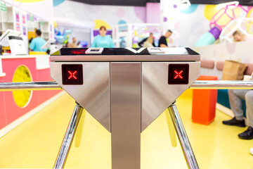 Closed two-way tripod turnstile in front of the entrance.