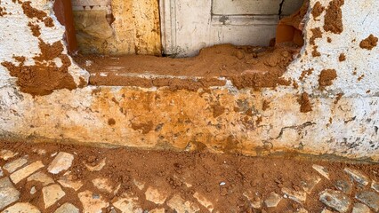 Crumbly rustic doorway dirt, earth-tone decay whispers stories of Festivus celebrations and...