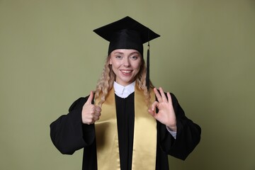 Happy student gesturing after graduation on green background