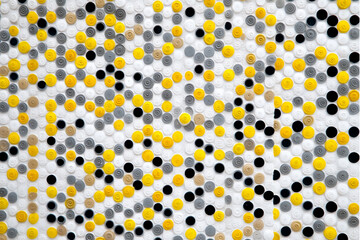 Abstract background of yellow gray black and white circles arranged in a dense and textured pattern
