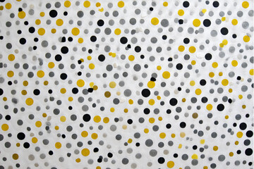 Abstract background featuring a pattern of yellow black and gray circles scattered on white surface