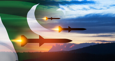 Fired missiles fly to the target. Missiles at the sky at sunset with Pakistan flag.