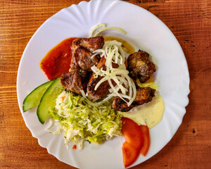 Grilled kebab with vegetables dish, Shish kebab with tomato, onion, cabbage