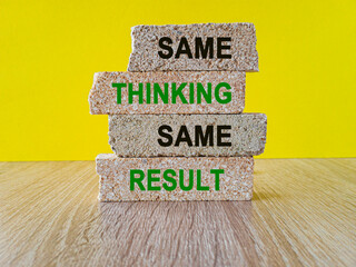 Brick blocks with words Same thinking same results on beautiful yellow background. Wooden table....