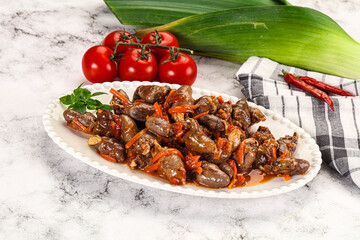 Baked chicken hearts with vegetables