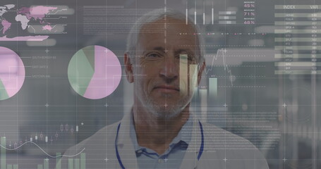 Statistical data processing against portrait of caucasian senior male doctor smiling at hospital