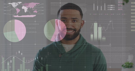 Statistical data processing against portrait of african american man smiling at office
