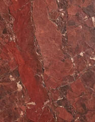 Obraz premium A striking display of red marble texture featuring intricate mineral patterns. This captivating stone illustrates the earths beauty and geological history in a unique way Generative AI