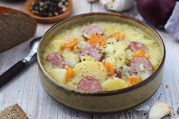 A bowl with traditional German potato soup with sausages