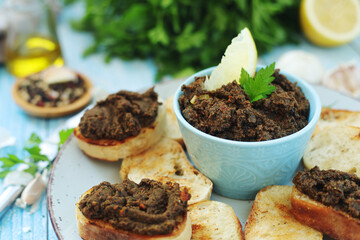 A bowl with tapenade - traditional olive dip in Mediterranean region	
