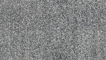 Seamless terrazzo cement background with small black and white stone grains scattered all over the concrete floor. Granite style pattern.