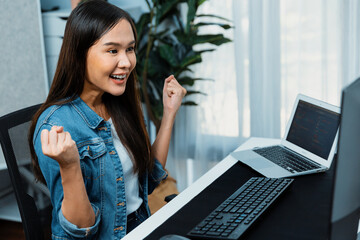 Smiling young Asian IT developer with happy face getting new software development information...
