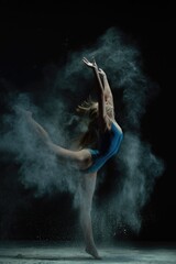 Dynamic dance performance with smoke effect showcasing athleticism and grace
