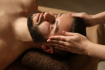 Fototapeta premium Man receiving relaxing massage in spa salon