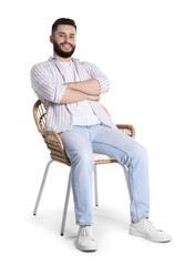 Smiling man relaxing on chair against white background