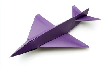 Homemade violet paper aircraft on white background
