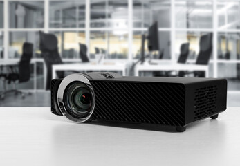 Modern video projector on white table in office