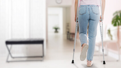 Woman with axillary crutches in hospital, closeup. Banner design