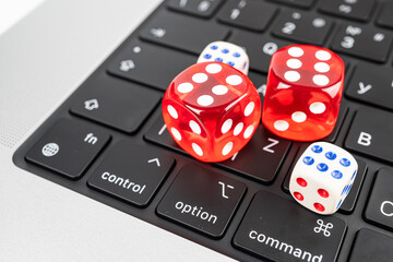 Three colorful dice on a computer keyboard with dots from 1 to 6 Scene suitable for technology, gambling, games, or decision-making marketingadvertising