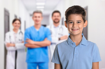 Cute child and medical staff in hospital. Pediatric ward
