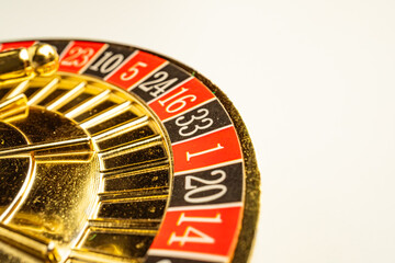 Close-up view of a golden, shiny slot machine with spinning reels