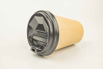 A single-serve coffee cup with a resealable lid, placed on a flat surface, suitable for hot beverages