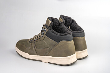 Olive green high-top sneakers with black accents, rugged design, contemporary style, thick rubber...