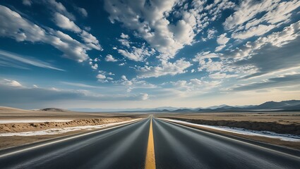 Dramatic cloudscape over an asphalt highway vanishing into the distant landscape