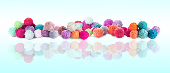 Knitting threads in different colors on light background with reflection