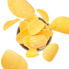 Tasty crispy potato chips falling into bowl on white background, top view