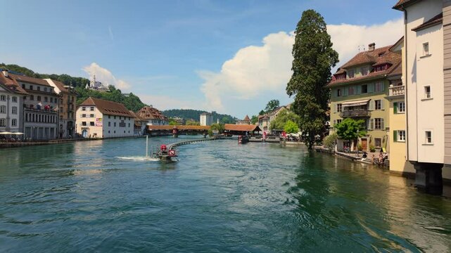 The Spreuer Bridge, a historic covered wooden footbridge, spans the Reuss River in the city of Lucerne, Switzerland. 4K UHD video.