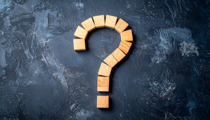 Intriguing question mark formed by wooden blocks on textured background