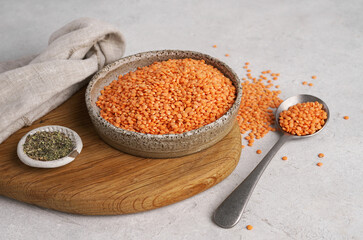 Red lentils in bowl. Dry orange lentil grains, heap of dal, raw daal, dhal, masoor, super foods, seeds and grains for vegan and vegetarian eating. Clean eating.