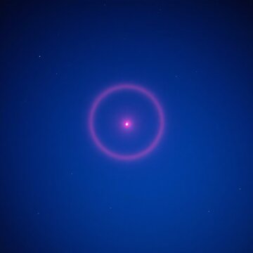 Halo de lumi&egrave;re rouge sur un fond bleu qui comporte des petites &eacute;toiles