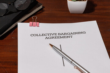 Collective Bargaining Agreement Document on Table – Foundation of Union and Employer Labor Relations