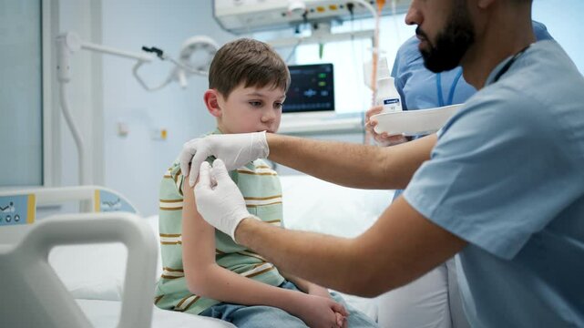 Doctor giving vaccine to young boy during childhood immunization.