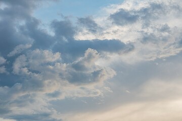 Overcast sky with various cloud formations, ranging from fluffy to dense, hinting at early morning or late afternoon light Wide and panoramic perspective