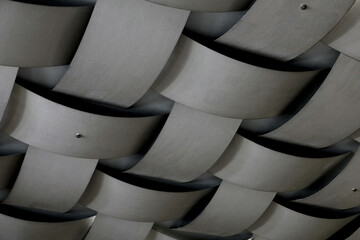 The concrete ceiling has a structure that resembles the bamboo woven square pattern