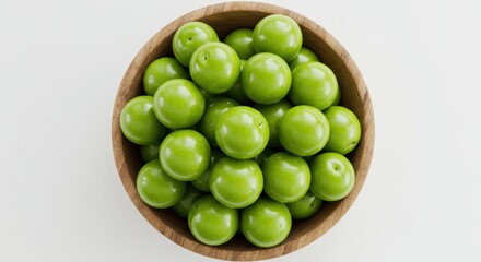 Unripe Green Plums in a Wooden Bowl