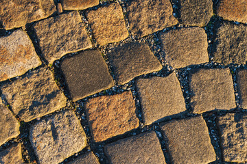 Ancient stone cobblestone close-up. Natural stone texture for background. Ideal for historical and...
