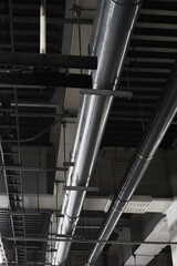 Piping and power distribution equipment in exposed ceilings of heavy steel frame buildings