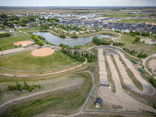View of a park with a baseball field and a pond